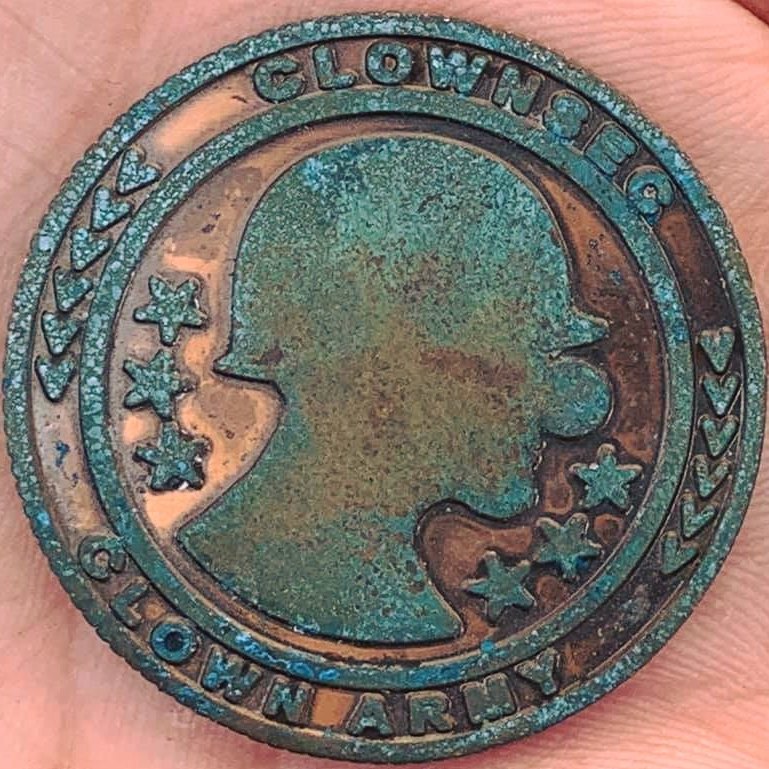 Copper coin showing green/blue patina from ammonia treatment